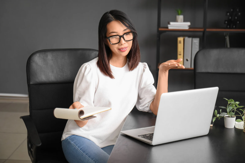 Woman on laptop doing outsourced HR work