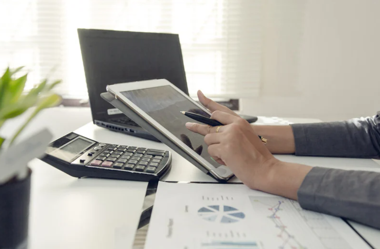 Someone doing finances on a calculator