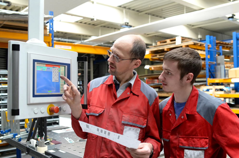 Younger and older man in industrial apprenticeship