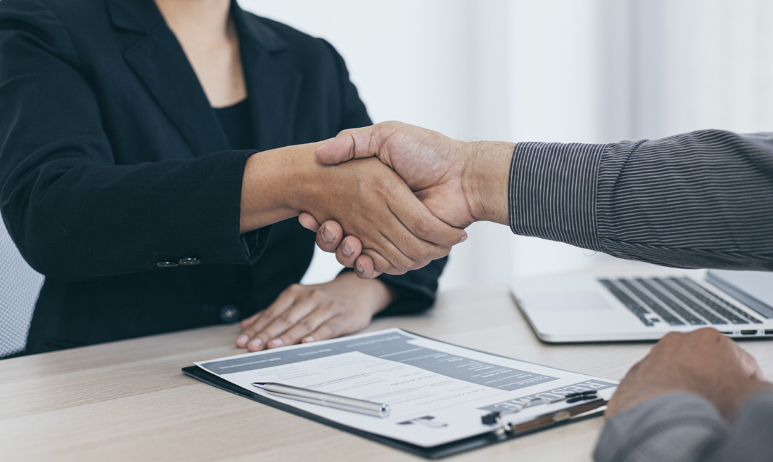 woman shaking man's hand