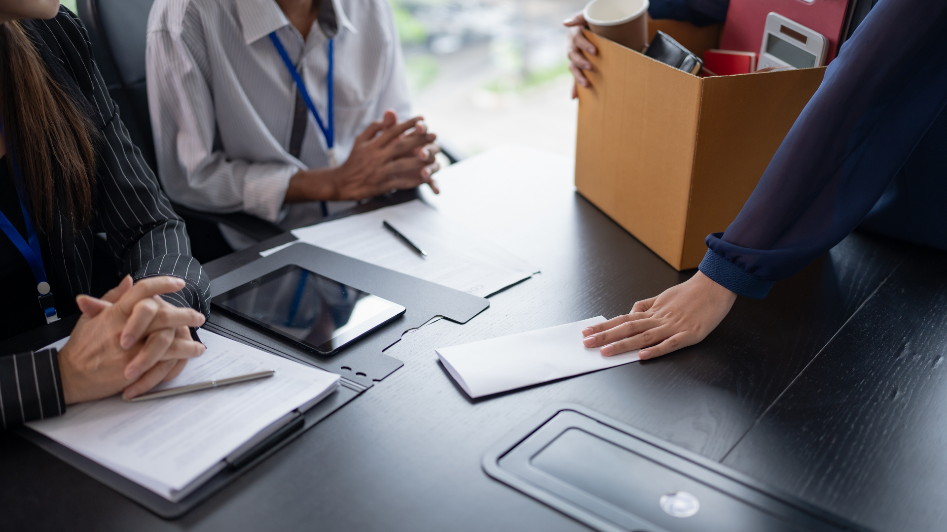 upclose of woman handing man a slip of paper