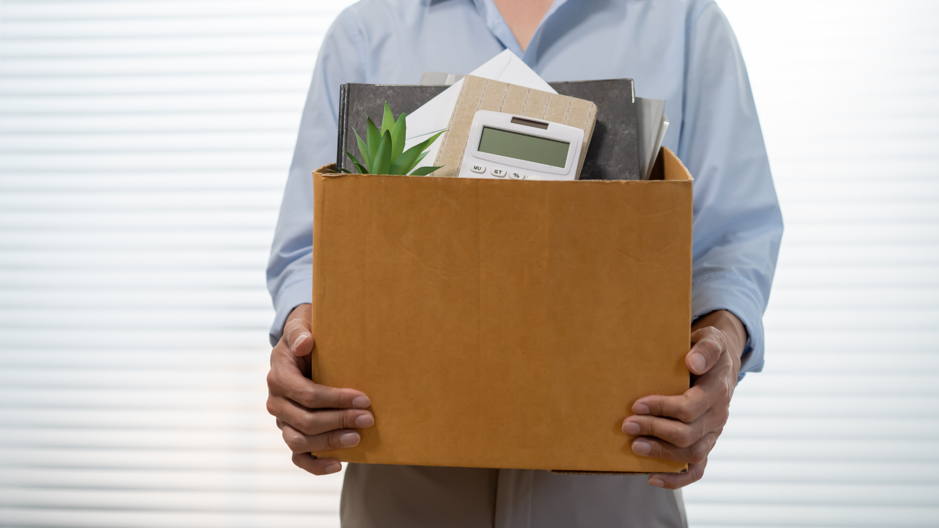 man with box full of office things