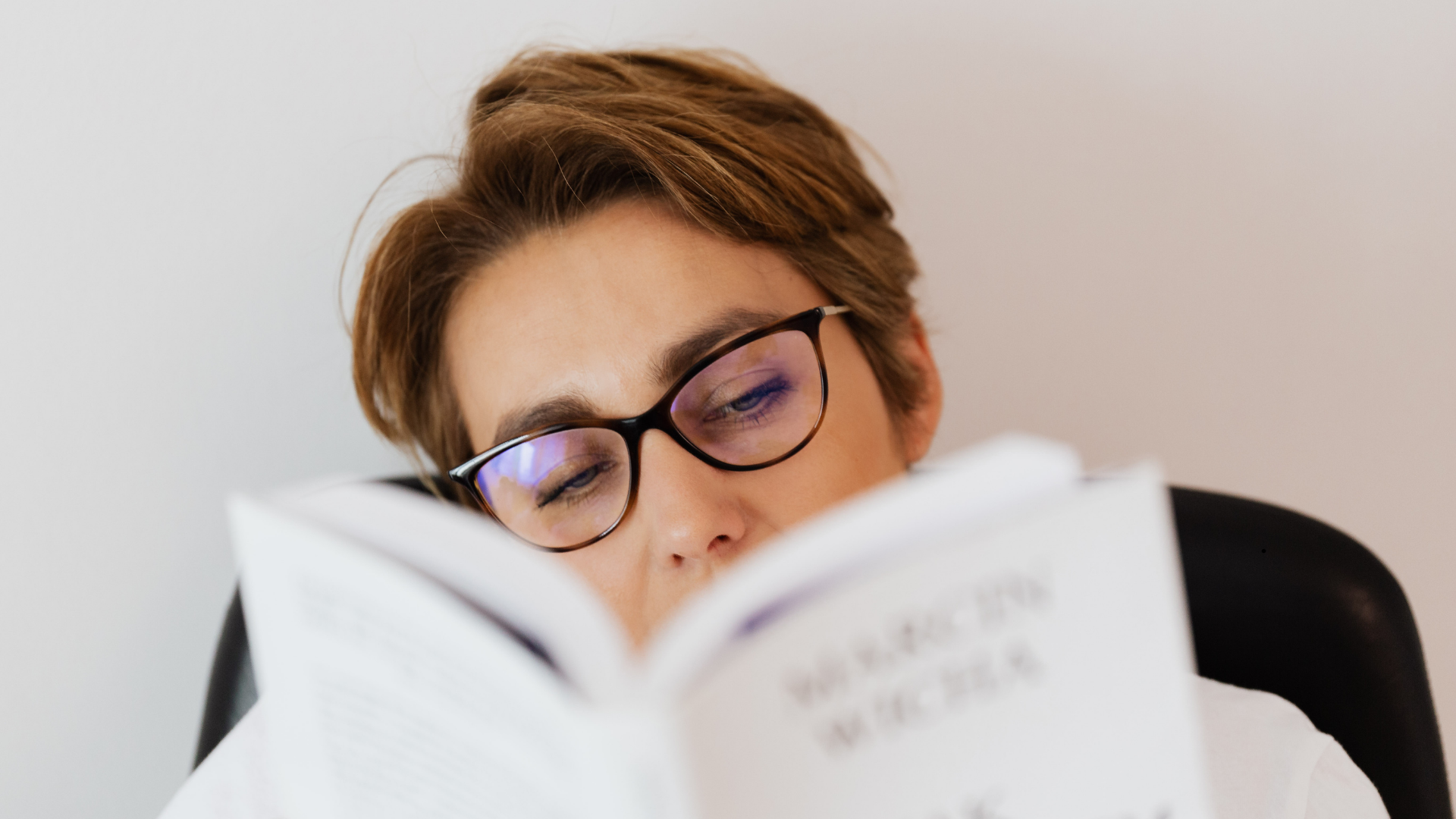 woman reading with glasses on